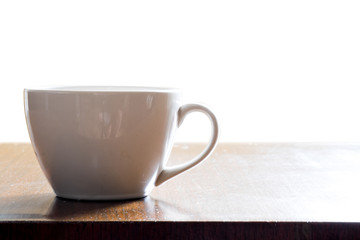 Isolated cup of hot coffee on wooden table