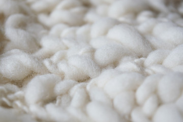 Fototapeta na wymiar White knitted woolen fabric