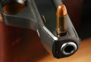 The pistol and bullet scene represent the weapon abstract concept related idea.