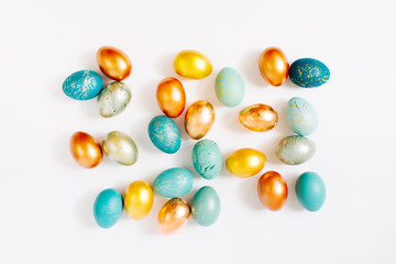 Fototapeta na wymiar Background with blue, gold and turquoise speckled easter eggs. Ester concept