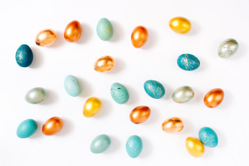 Fototapeta na wymiar Pattern background with blue, gold and turquoise speckled easter eggs. Ester concept