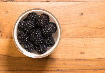 From above view of glass bowl of blackberries