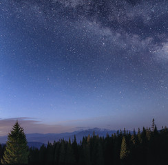 Fototapeta premium Night sky with Milky Way over the mountain landscape