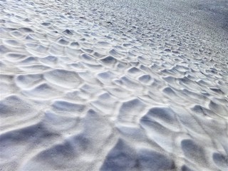 A large snow patch left over on the north side of a mountain in summer