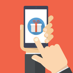 Hand holding smartphone with gift box on the screen. Finger touch the box. Vector flat illustration.