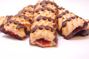 Pile of shortbread cookies with jam and chocolate icing