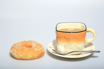 Hot coffee in the cup with sugar donuts, as foods background or print card.