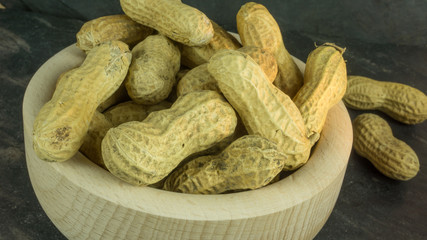 Dry peanuts in a wooden bowl
