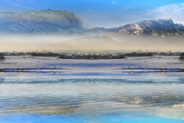 Krajobraz zimowy, odbicie w jeziorze wioski i gór. © Stanisław Błachowicz