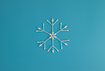 Figure snowflakes of cotton sticks. Pattern on blue background. Flat lay minimal concept. Top view. - 137585855