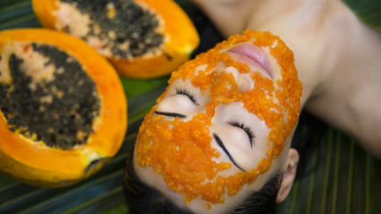 Beautiful woman having fresh papaya facial mask apply. fresh papaya