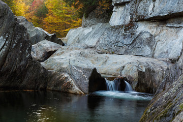 Autumn Waterfall through Grey Granite boulders