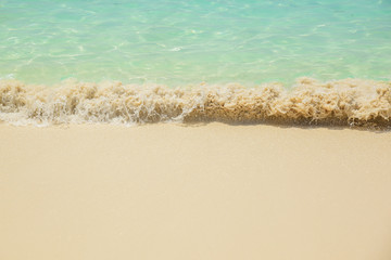 Fototapeta na wymiar Sea waves breaking on sandy beach as background resources
