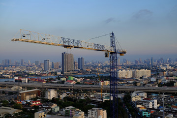 Fototapeta na wymiar Construction tower crane with city background