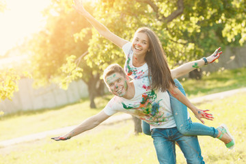Pretty young couple making a plane or aircraft. Beautiful girl and handsome man having fun outdoors. Looking at camera