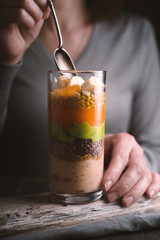 Woman eating a smoothie with avocado and pumpkin