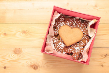 Box of sweet cookies on wooden background. Heart shape. View from above