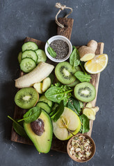 Detox green vegetables and fruits on a wooden board. Concept of a healthy, diet food. Smoothie ingredients.Top view
