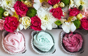 Rose marshmallows and beautiful flowers on a white background wo