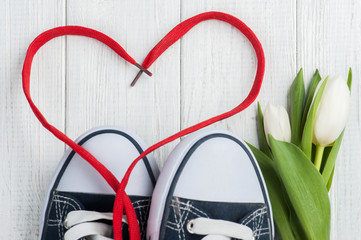 Red heart shape from laces and blue sneakers