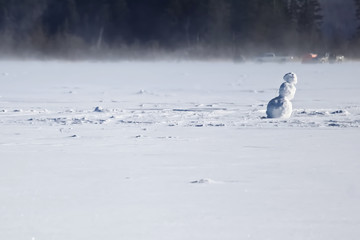 Lonely Snowman on the Middle of a Frozen Lake