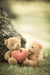 two bear dolls and red heart with dramatic tone, select focus the one bigger