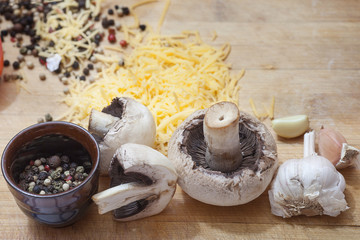 mushrooms with peppers and cheese on a cutting table