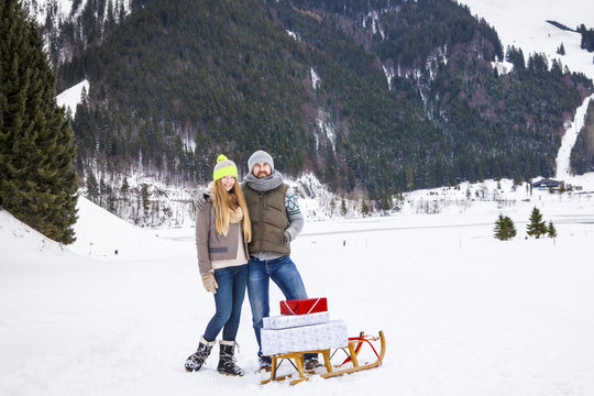 Couple Pulling Gifts On Sled, Spitzingsee, Bavaria, Germany