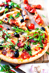 Hot pizza slice with Pepperoni, melting cheese on a rustic wooden table close up...