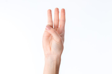 female hand stretched up and showing three fingers isolated on white background