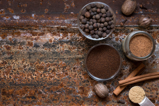 Warm spices on rusty metal background
