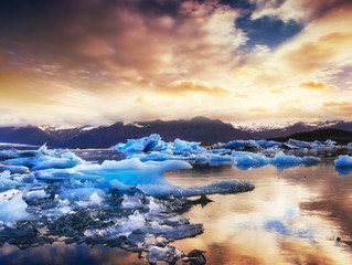Jokulsarlon glacier lagoon, fantastic sunset on the black beach,
