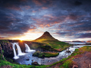The picturesque sunset over landscapes and waterfalls. Kirkjufel