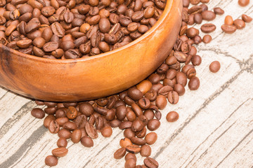Roasted coffee beans in a wooden bowl