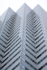 Angled protrusions of tall buildings of glass and concrete financial and business center of the modern city