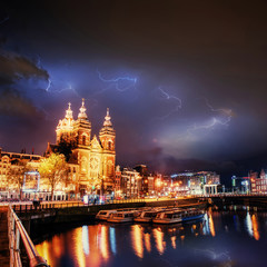 Amsterdam canal. Lightning strike on the cloudy dark sky.