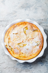 Apple dutch pancake, cake in a baking dish. Grey stone background. Top view.