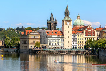 View of the church clock in Prague with the Vltava river in front
