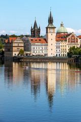 Fototapeta na wymiar View of the church clock in Prague with the Vltava river in front