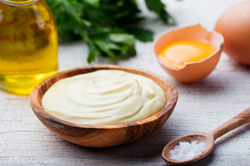Homemade mayonnaise, mayo in a wooden bowl. White background