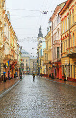 Fototapeta na wymiar Kobylianska street in Chernivtsi, Ukraine in the rainy weather