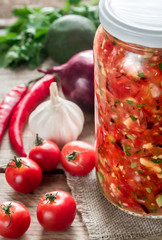 Jar of salsa with ingredients