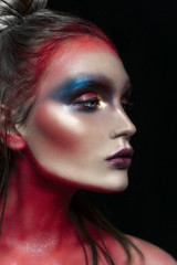 Beauty close-up portrait of beautiful woman model face with magic creative fashion multicolored make-up. Face painting, cosmetics, beauty and makeup.