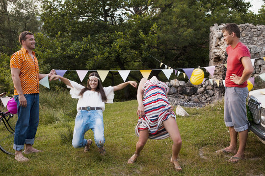 Croatia, Dalmatia, Young women dancing outdoors, men watching