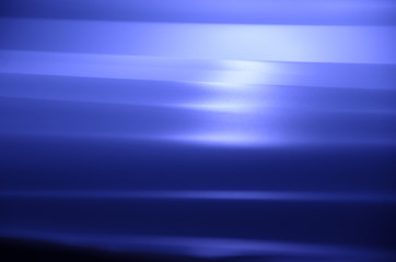 Smooth creases and folds on a fabric with dull light and deep shadows	