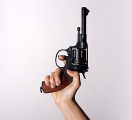 Woman's hand with a gun on a white background