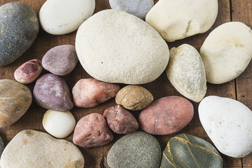 Fototapeta na wymiar different stones on wooden background