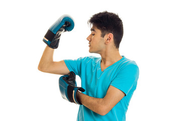 portrait of powerful brunette sports man practicing box in blue gloves isolated on white background