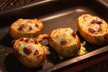 Baked stuffed potatoes in the kitchen oven.