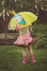Little girl having fun after raining
